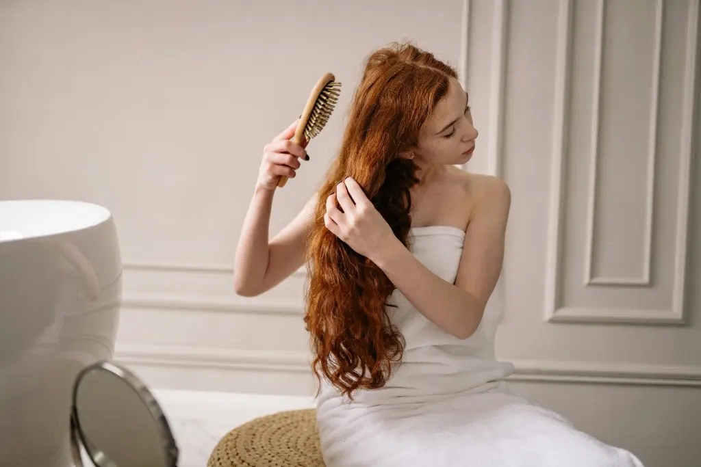 Can You Use Baby Powder as Dry Shampoo? 5 Woman in White Bath Towel Holding Brown Hair Brush