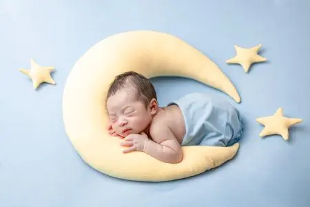 Baby sleeping on moon pillow