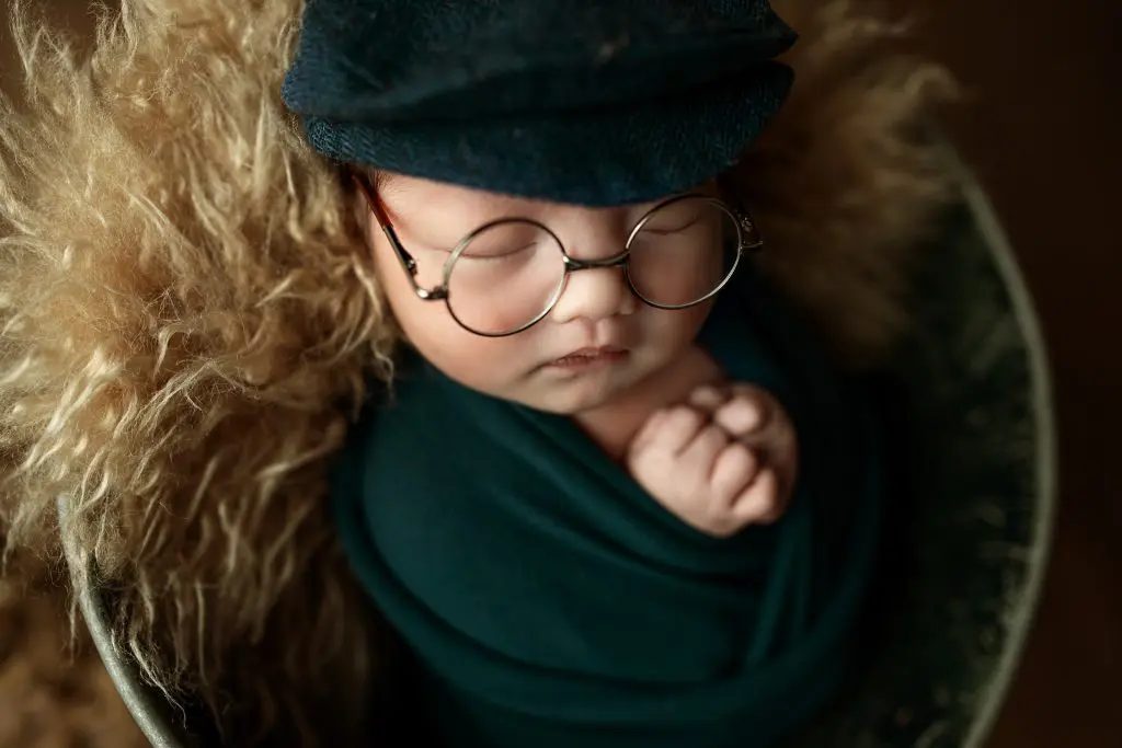 140+ Unique Boy Names That Start With R 15 Newborn baby sleeping wearing glasses