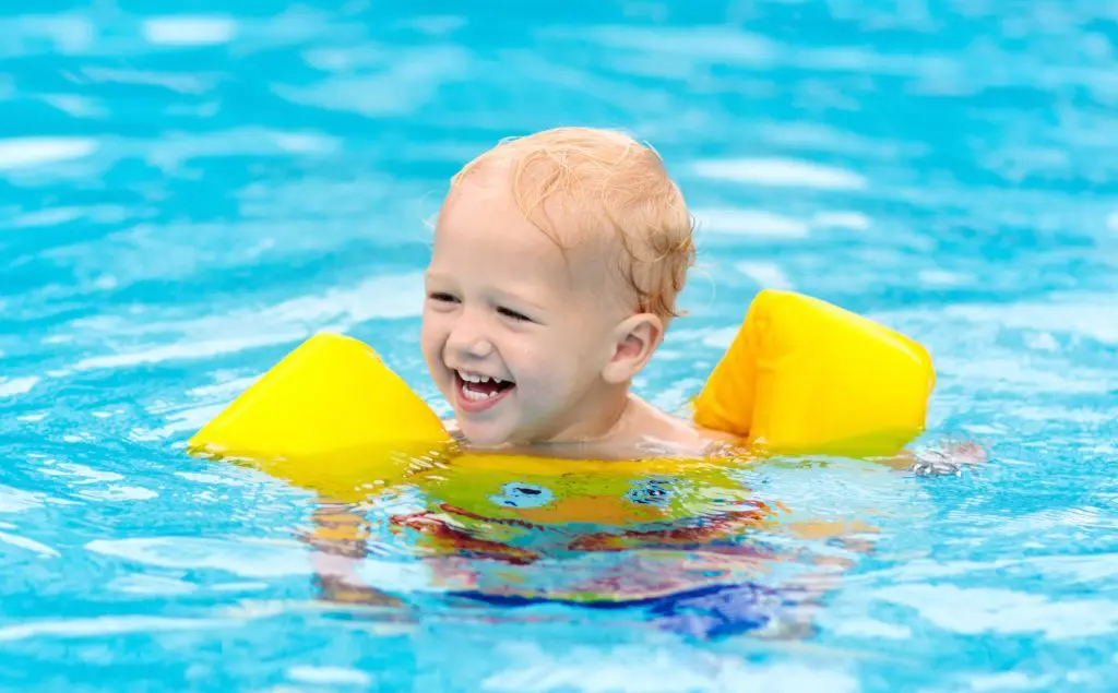 Baby playing in swimming pool