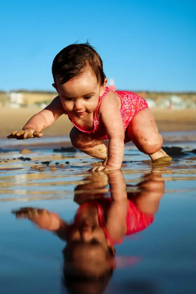 Baby crawling on beach