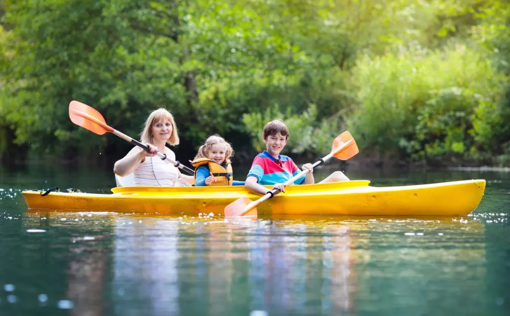 Child on kayak during summer camp