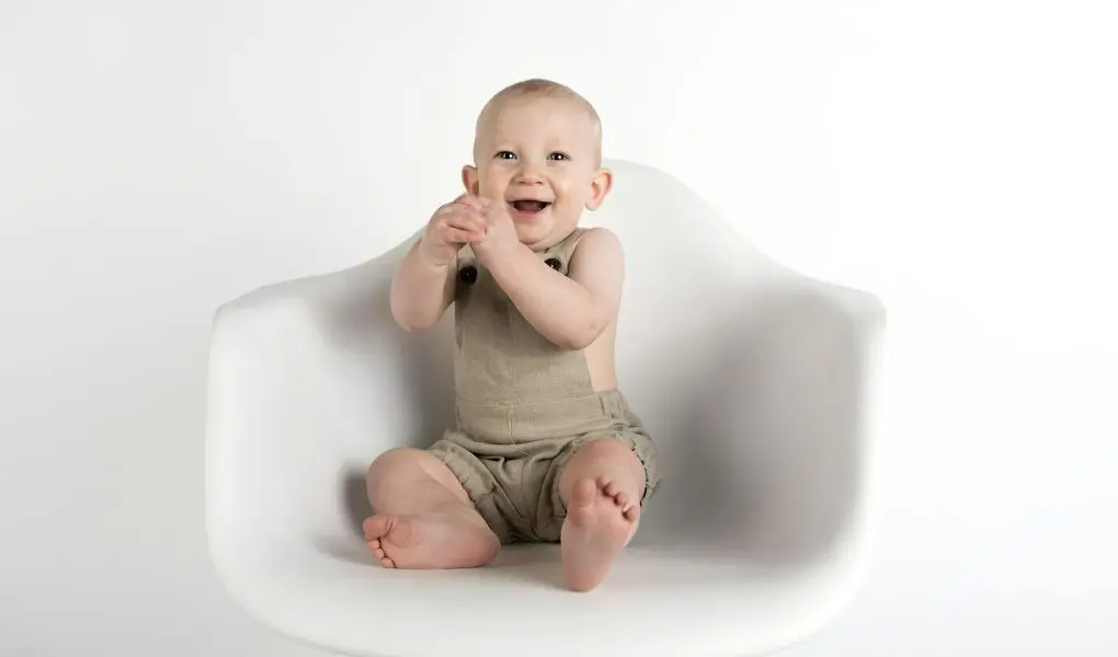Baby Sitting on White Chair