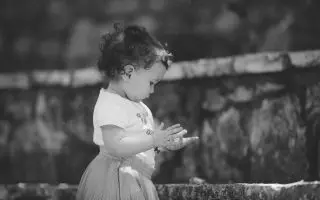 A Toddler Standing Near the Concrete Stairs - Featured