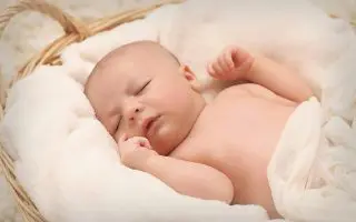 Baby Sleeping on White Cotton - Featured