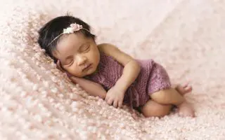Toddler Lying on Pink Fleece Pad - Featured
