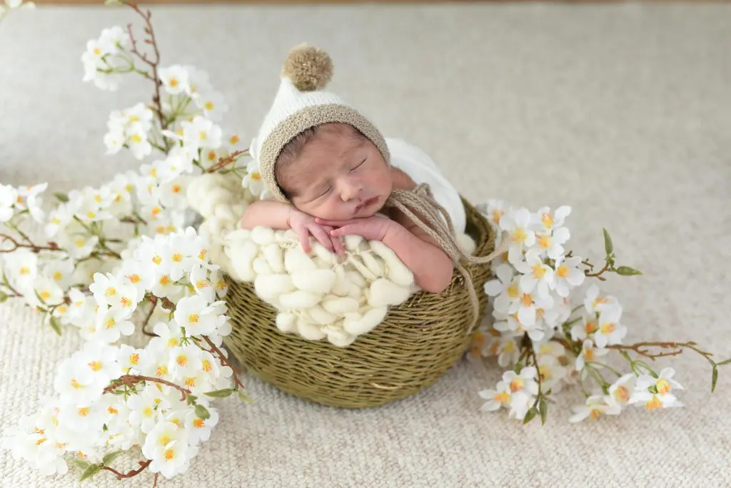100 Romantic Boy Names That Will Steal Your Heart 6 Adorable Newborn in Cozy Basket with Flowers