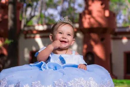 Four Syllable Girl Names (Graceful, Bold, and Unique) 2 Baby Girl Wearing a Gown - Featured