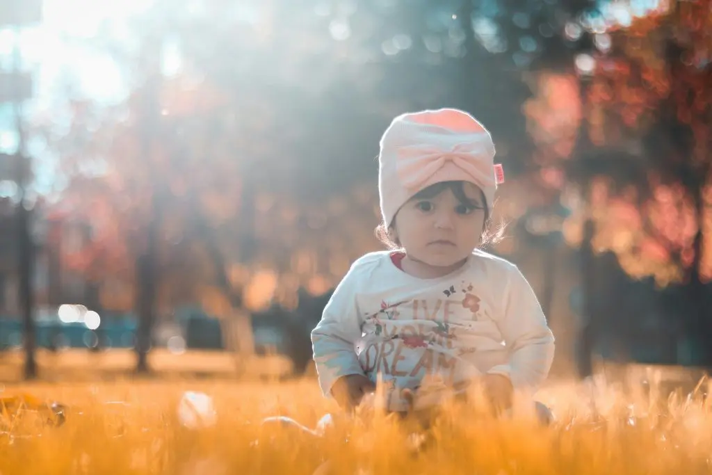 100+ Unique Girl Names That Start With G 12 Photo of Toddler Sitting on Grass