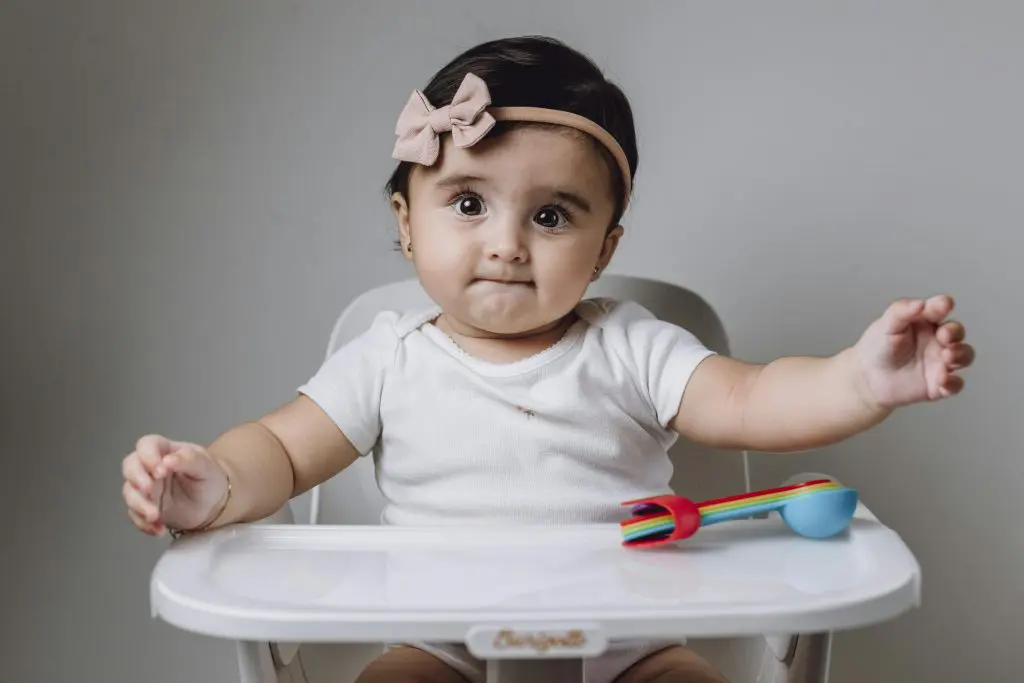 200 Unique Girl Names That Start With S 13 Baby Girl Sitting on Chair with Table