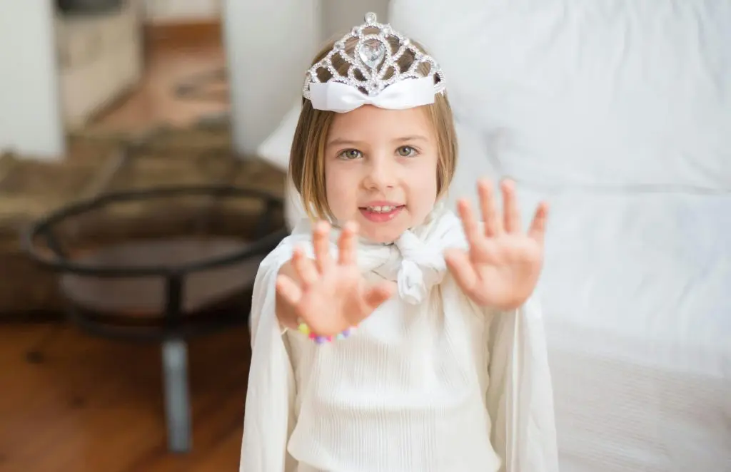 Girl Wearing Crown Extending Her Arms