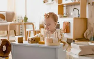 Adorable Baby Playing with Wooden Blocks - Featured