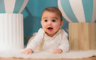 Adorable Baby Playing Indoors with Colorful Decor - Featured