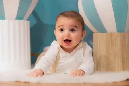 Adorable Baby Playing Indoors with Colorful Decor - Featured