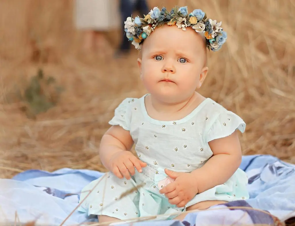 Unique Girl Names That Start With A 6 Toddler in a Flower Crown Sitting in a Wheat Field