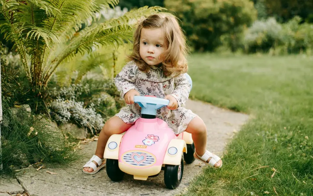 Unique Girl Names That Start With A 14 A Young Girl Sitting on a Car Toy