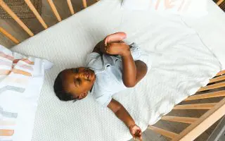 Baby in a Crib - Featured
