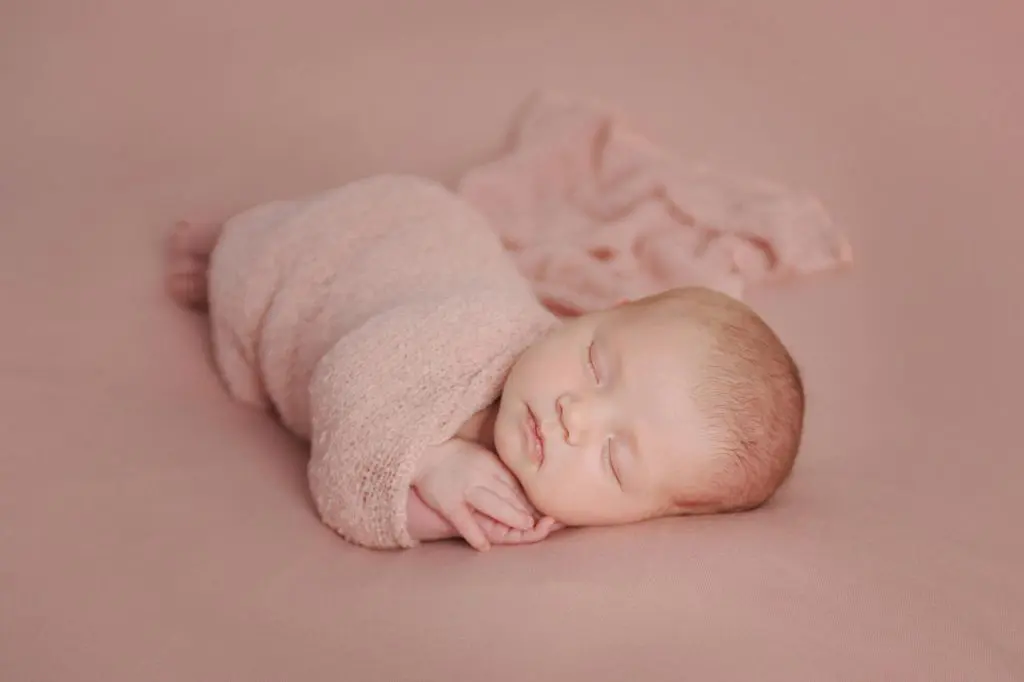 250+ Timeless & Unique Mythological Boy Names 6 A Newborn Baby Wrapped in a Pink Blanket