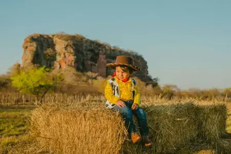350 Handsome Southern Boy Names 1 Boy in Woody Costume Sitting on Hay - Featured