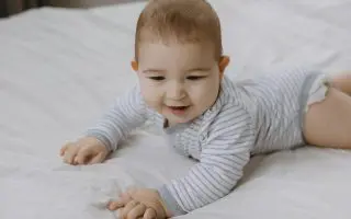 Adorable Baby Crawling on Bed in Cozy Room - Featured