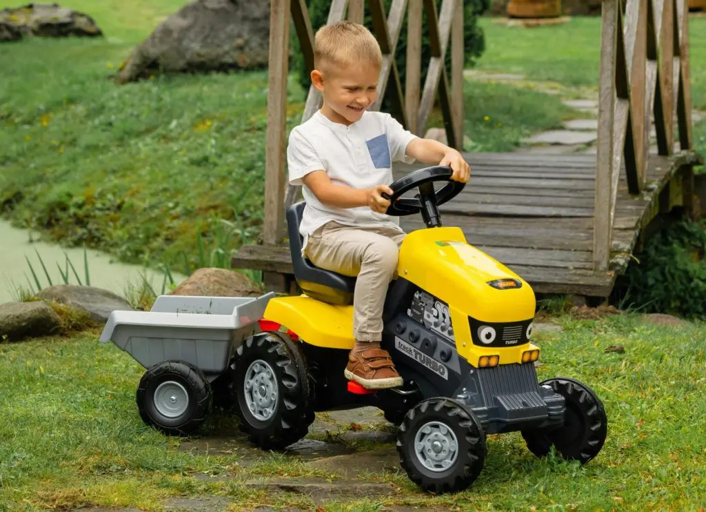 Boy Playing with Toy Tractor