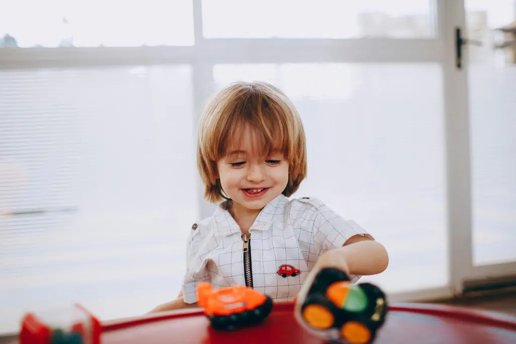 180 German Girl Names With Meanings 6 Smiling Boy Sitting and Playing with Toys