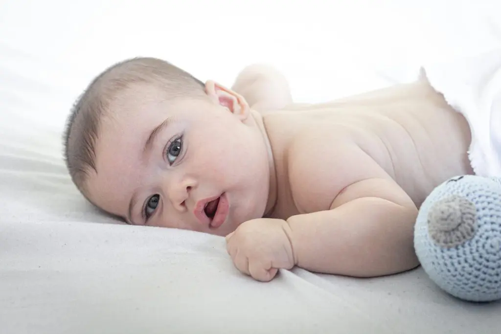 100 Unique Boy Names That Start With S 4 Cute Baby Lying on White Fabric