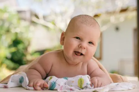 An Adorable Baby Smiling - Featured