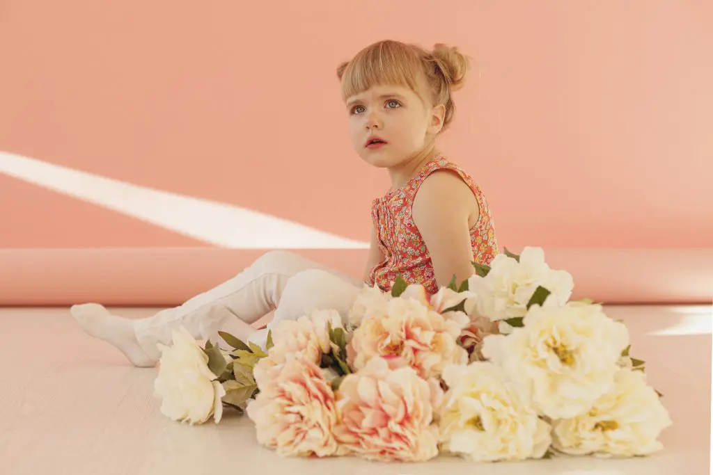 Beautiful toddler with flower bouquet