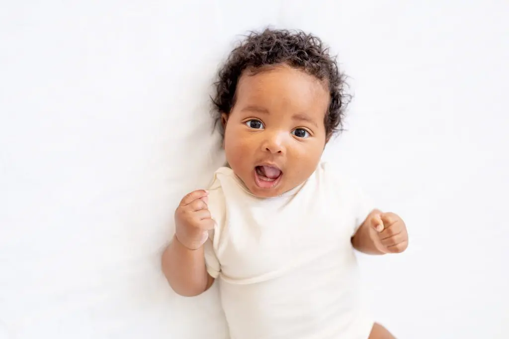 Small African American baby girl in a white bodysuit