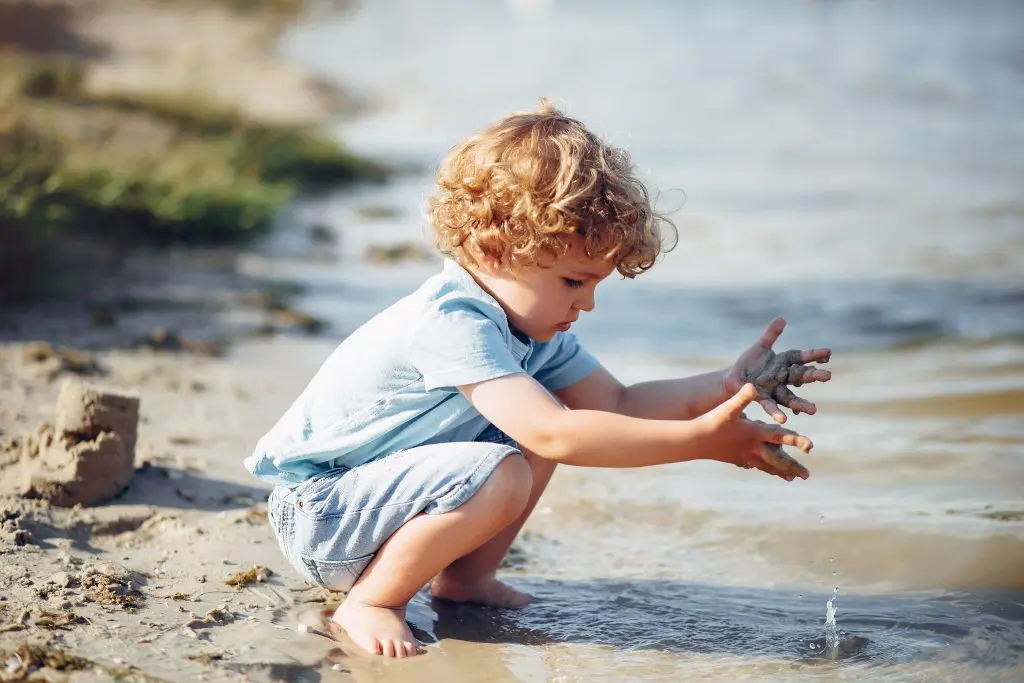 Cute little children playing on a sand