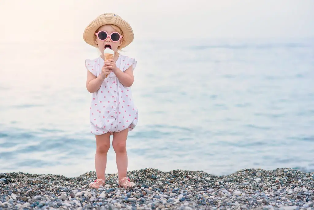 125 Beachy Girl Names With Meanings 11 Funny toddler girl wearing pink summer overalls
