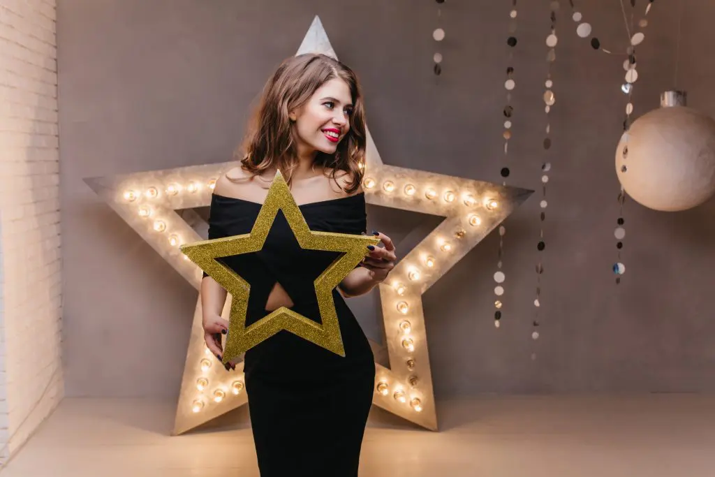 30 Twinkle Twinkle Little Star Baby Shower Ideas for a Stellar Baby Shower 12 Girl Posing with Star Cutout