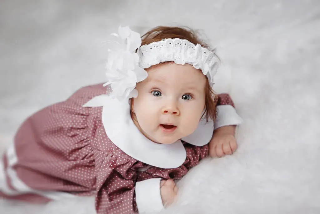 Little girl lying and looking at the camera