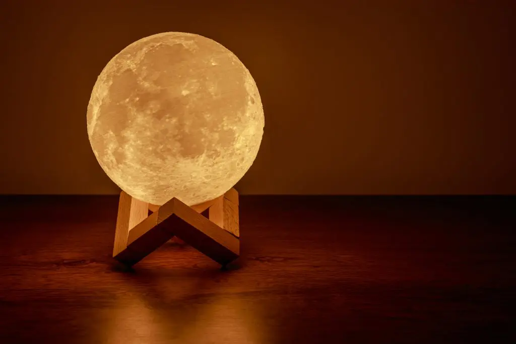 30 Twinkle Twinkle Little Star Baby Shower Ideas for a Stellar Baby Shower 15 Moon lamp on the table