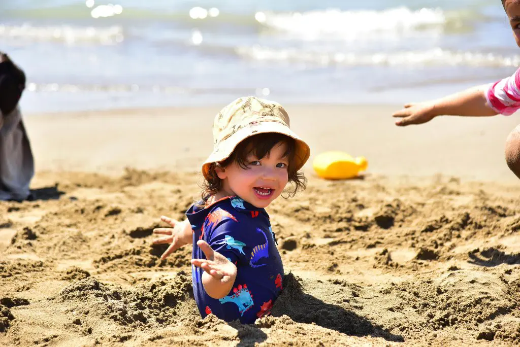 125 Beachy Girl Names With Meanings 5 A Boy in Blue Shirt Playing on the Beach