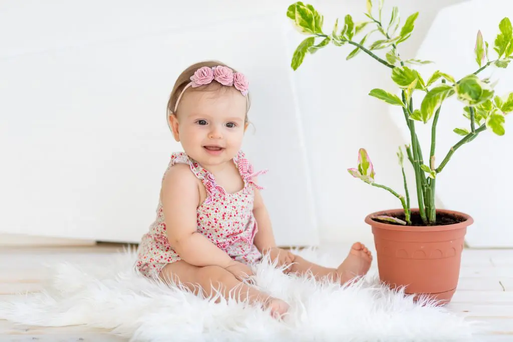 smiling little child girl sitting in a bright white room