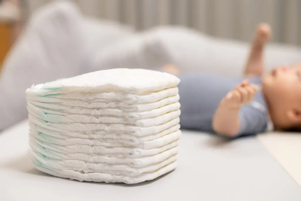 Stack of Soft Diapers with Newborn Baby Resting