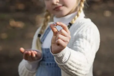 80 Gemstone Girl Names For Your Little Jewel 1 Girl holding stone