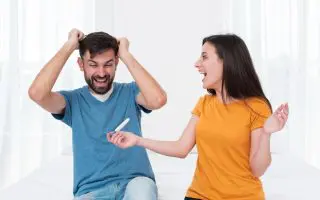 Excited couple holding pregnancy test