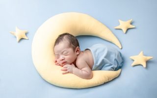 Baby sleeping on moon pillow