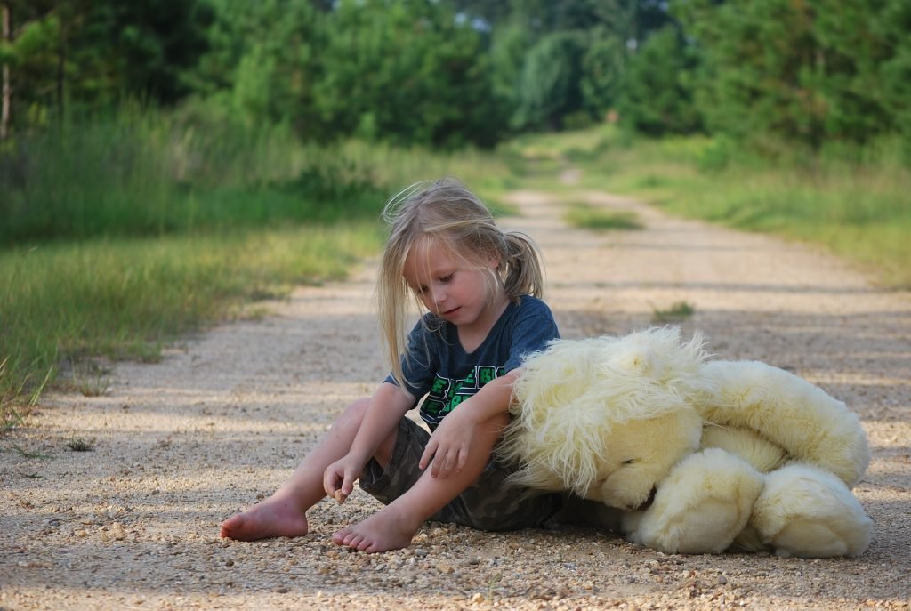 Girl with teddy bear toy