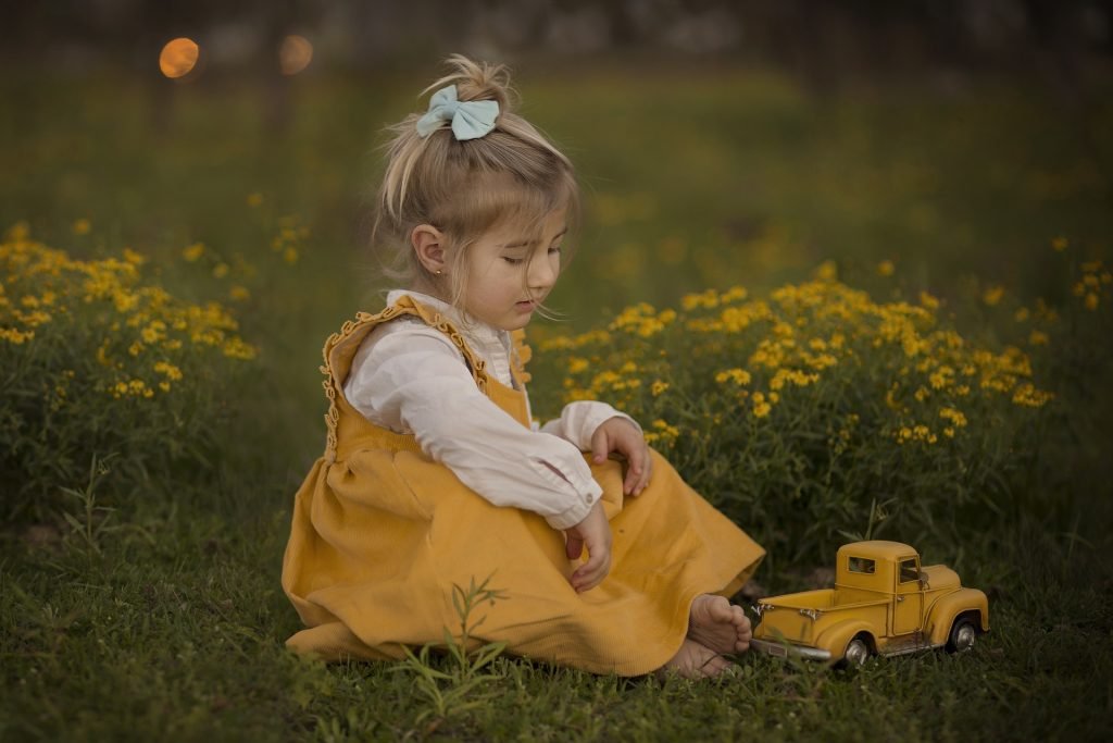 Girl playing with a car