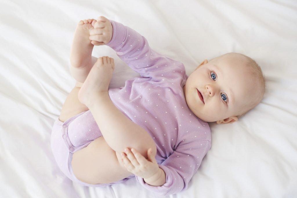 Baby Girl lying on bed