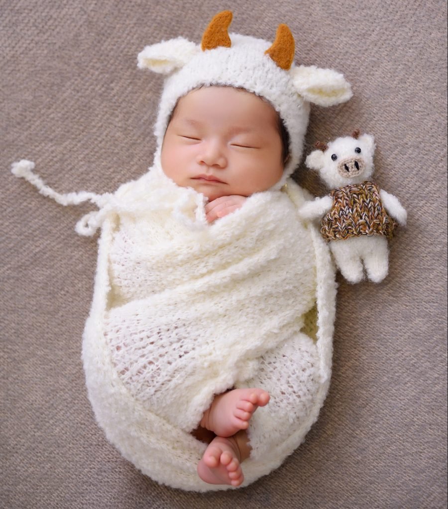 Newborn baby in a white costume