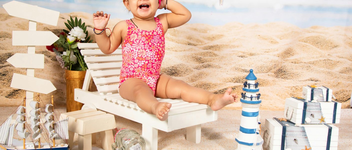 Girl Wearing Pink Swimsuit Among Toys - Featured