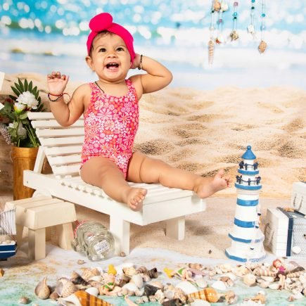 Girl Wearing Pink Swimsuit Among Toys - Featured