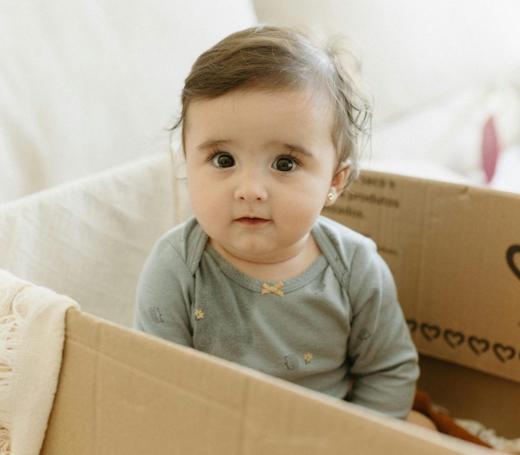 Little Girl sitting inside a Box