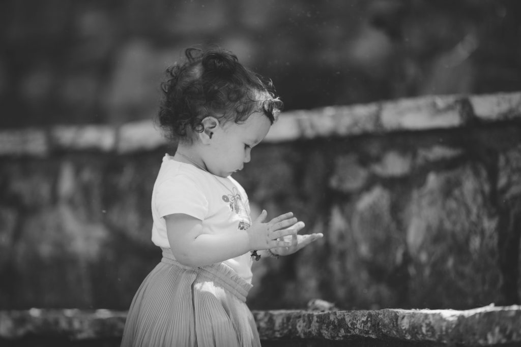 A Toddler Standing Near the Concrete Stairs