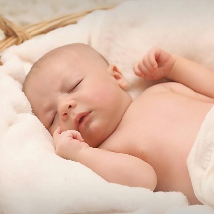 Baby Sleeping on White Cotton - Featured